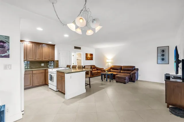 a kitchen with kitchen island granite countertop a sink and stove