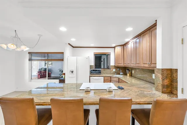 a large kitchen with kitchen island a sink stainless steel appliances and cabinets