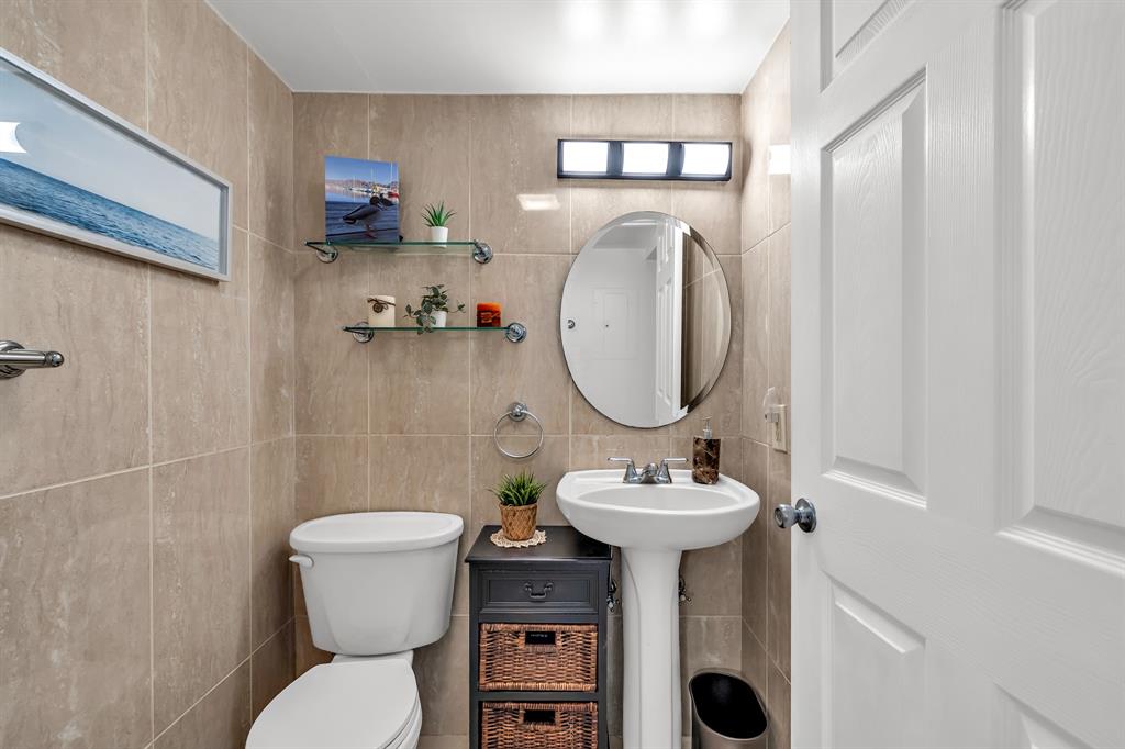 2835 Northeast 28th Avenue, Unit 3 Lighthouse Point, FL 33064 - Photo 20 of 30 a bathroom with a toilet sink and mirror