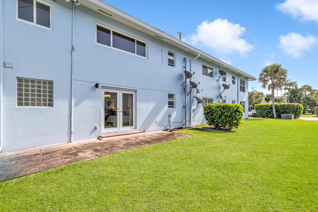 2835 Northeast 28th Avenue, Unit 3 Lighthouse Point, FL 33064 - Photo 23 of 30 a backyard of a house with plants and barbeque grill
