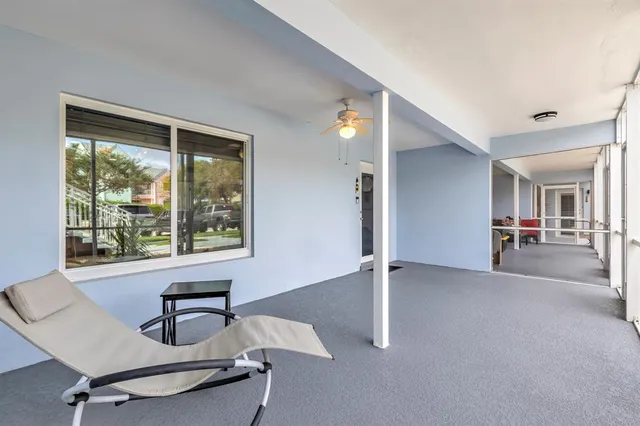 a view of a house with a swimming pool and sitting area