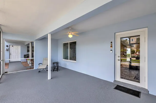 a view of an empty room with a floor to ceiling window and a table
