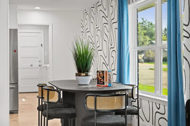 a bedroom with two beds and a chandelier