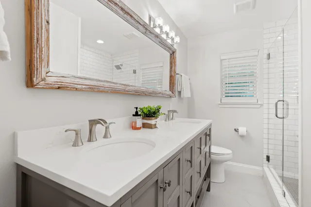 a bedroom with two beds and a large window