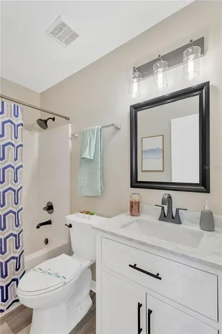 a bathroom with a sink toilet tub and shower