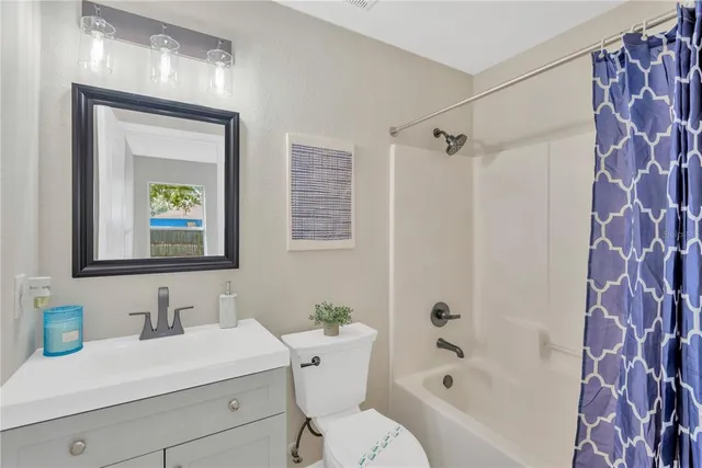 a bathroom with a sink mirror toilet and bathtub