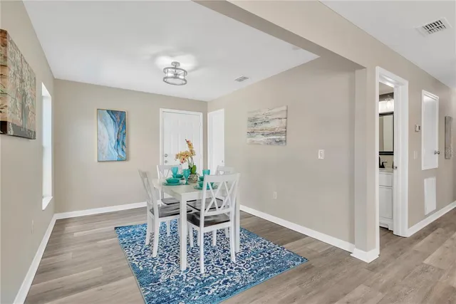 a dining room with wooden floor and a dining table