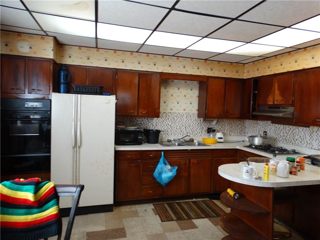 121 Cutler Street McKees Rocks, PA 15136 - Photo 5 of 17 a kitchen with stainless steel appliances granite countertop a sink refrigerator and cabinets