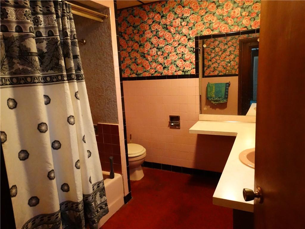 121 Cutler Street McKees Rocks, PA 15136 - Photo 6 of 17 a bathroom with a toilet and a shower curtain