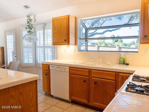 5011 Steeplegate Lane Santa Maria, CA 93455 - Photo 12 of 31 a kitchen with stainless steel appliances a sink stove and cabinets