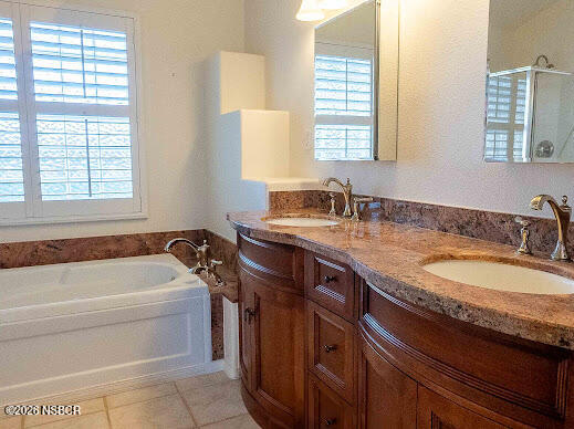 5011 Steeplegate Lane Santa Maria, CA 93455 - Photo 22 of 31 a bathroom with a granite countertop bathtub a sink and a window