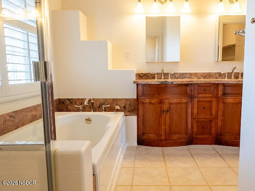 5011 Steeplegate Lane Santa Maria, CA 93455 - Photo 24 of 31 a bathroom with a tub sink and mirror