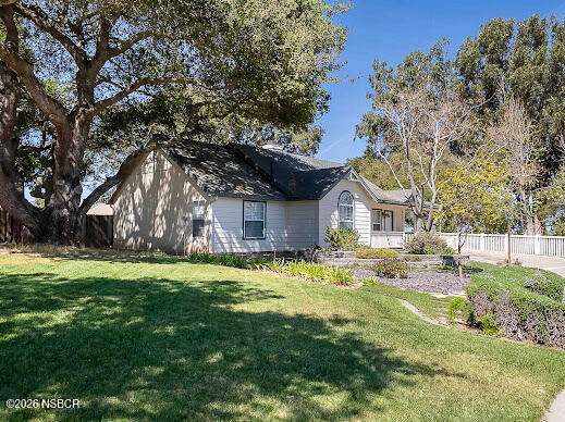 5011 Steeplegate Lane Santa Maria, CA 93455 - Photo 4 of 31 a yellow house sitting in middle of the middle of a yard