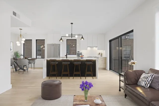a living room with furniture and kitchen view