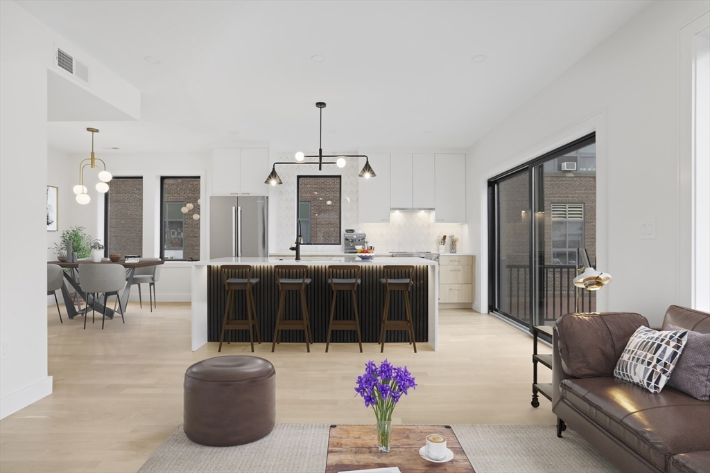a living room with furniture and kitchen view