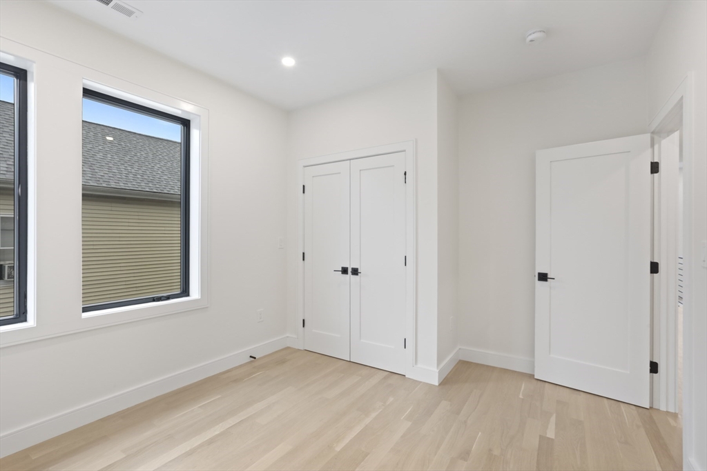 14 Bonair Street, Unit 14 Somerville, MA 02145 - Photo 12 of 39 a view of an empty room with closet and a window