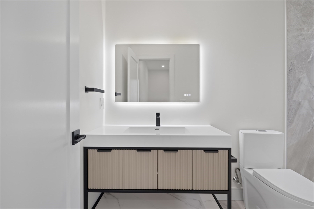 14 Bonair Street, Unit 14 Somerville, MA 02145 - Photo 16 of 39 a bathroom with a sink a toilet and mirror