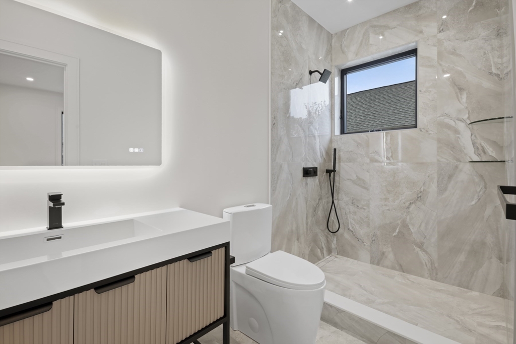 14 Bonair Street, Unit 14 Somerville, MA 02145 - Photo 17 of 39 a bathroom with a sink a toilet and shower