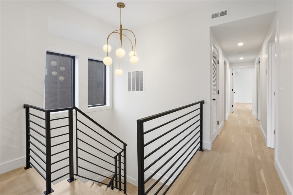 14 Bonair Street, Unit 14 Somerville, MA 02145 - Photo 19 of 39 a view of a hallway with a chandelier