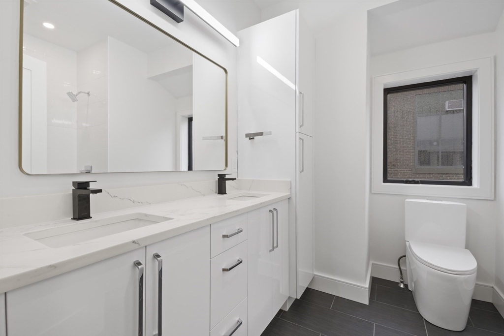 14 Bonair Street, Unit 14 Somerville, MA 02145 - Photo 22 of 39 a bathroom with a toilet sink and mirror