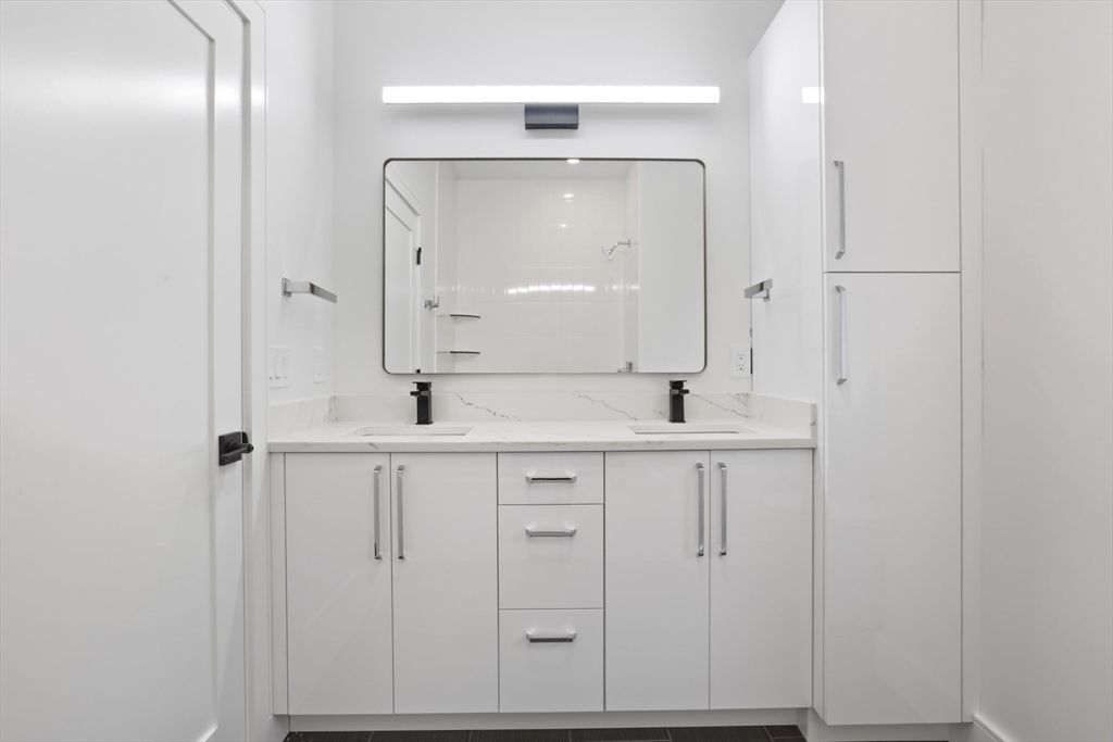14 Bonair Street, Unit 14 Somerville, MA 02145 - Photo 23 of 39 a bathroom with double vanity sink and mirror