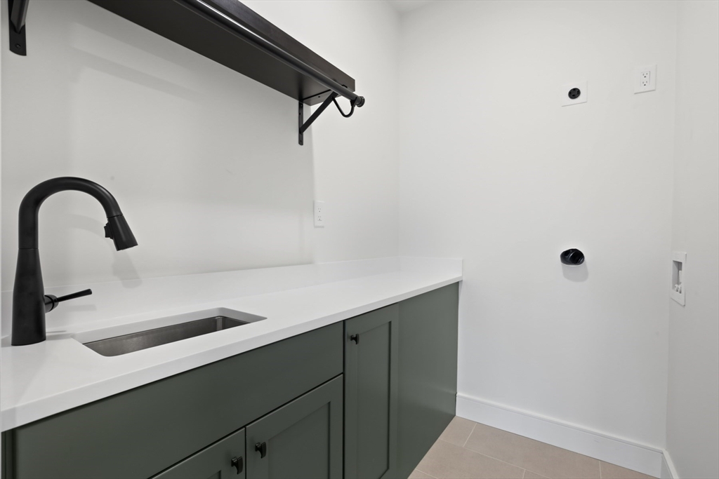 14 Bonair Street, Unit 14 Somerville, MA 02145 - Photo 25 of 39 a close view of a sink a mirror and shower in the background