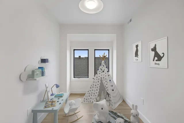 a bed sitting in a bedroom next to a window