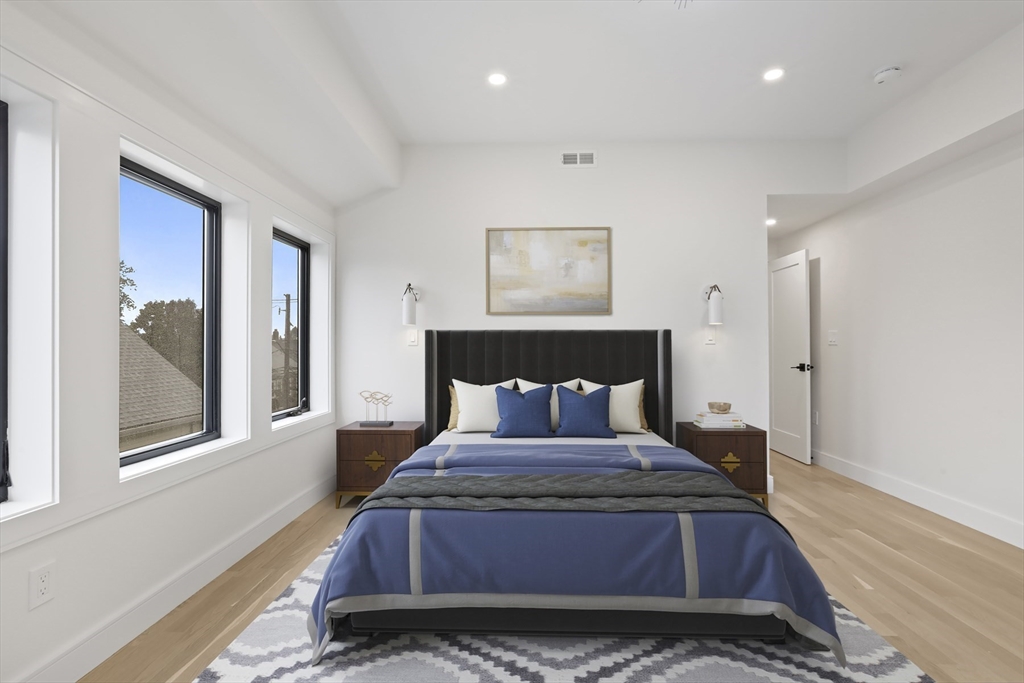 14 Bonair Street, Unit 14 Somerville, MA 02145 - Photo 28 of 39 a bed sitting in a bedroom next to a window