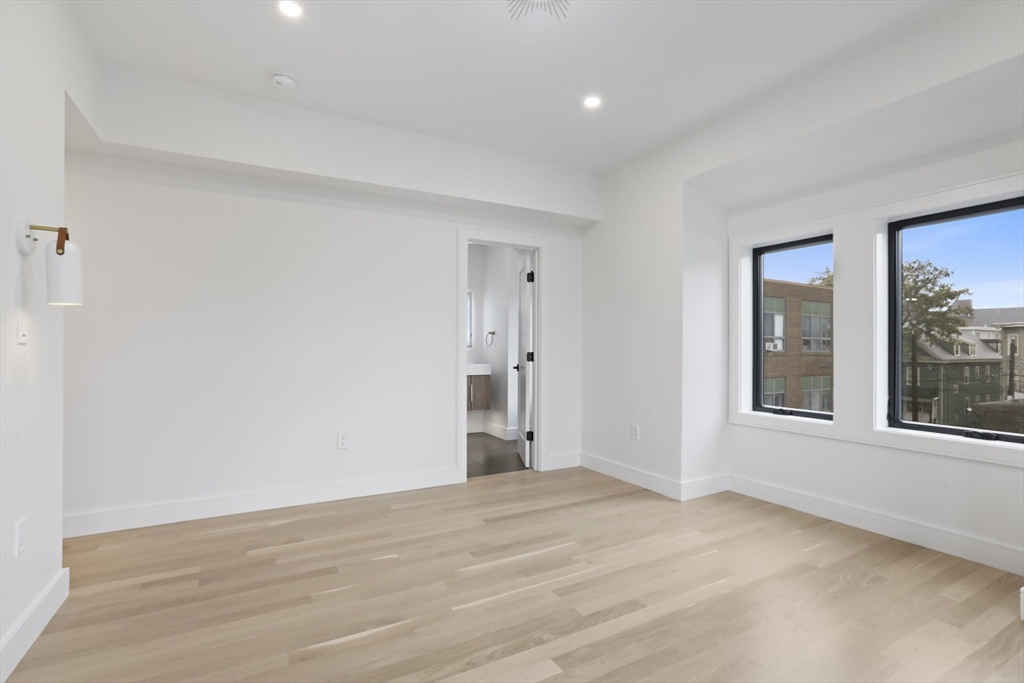 14 Bonair Street, Unit 14 Somerville, MA 02145 - Photo 29 of 39 a view of empty room with wooden floor and fan