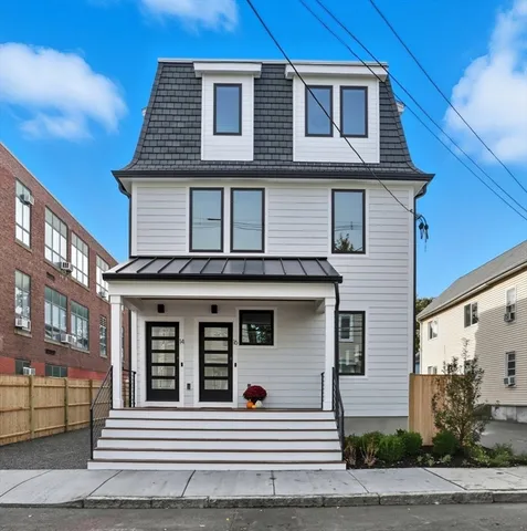a view of a house with a wooden deck