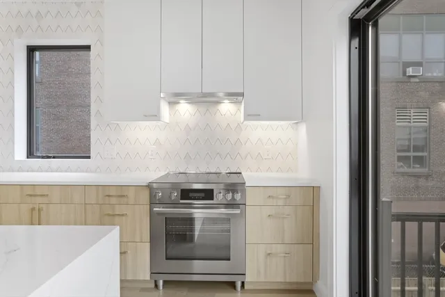 a kitchen with a refrigerator and a sink