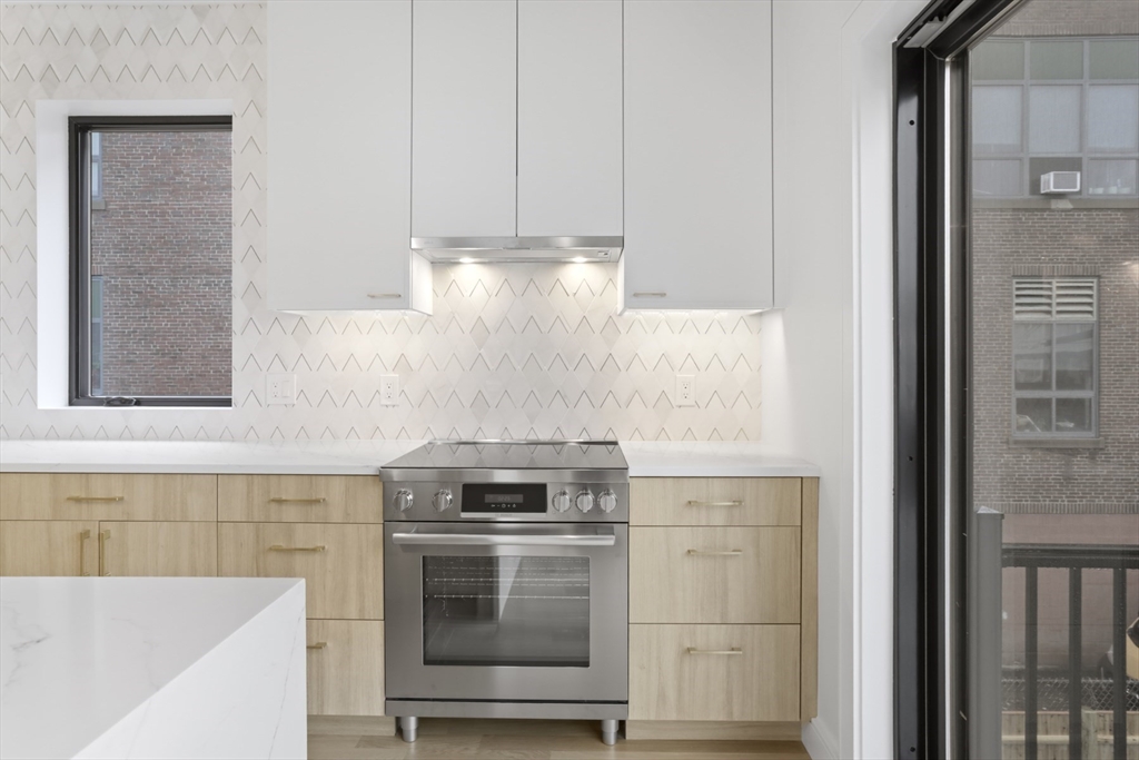 14 Bonair Street, Unit 14 Somerville, MA 02145 - Photo 5 of 39 a kitchen with a stove and a sink