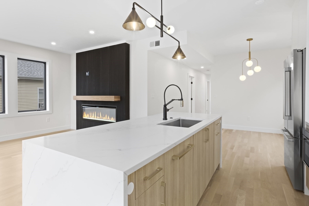 14 Bonair Street, Unit 14 Somerville, MA 02145 - Photo 6 of 39 a kitchen with a refrigerator and a sink