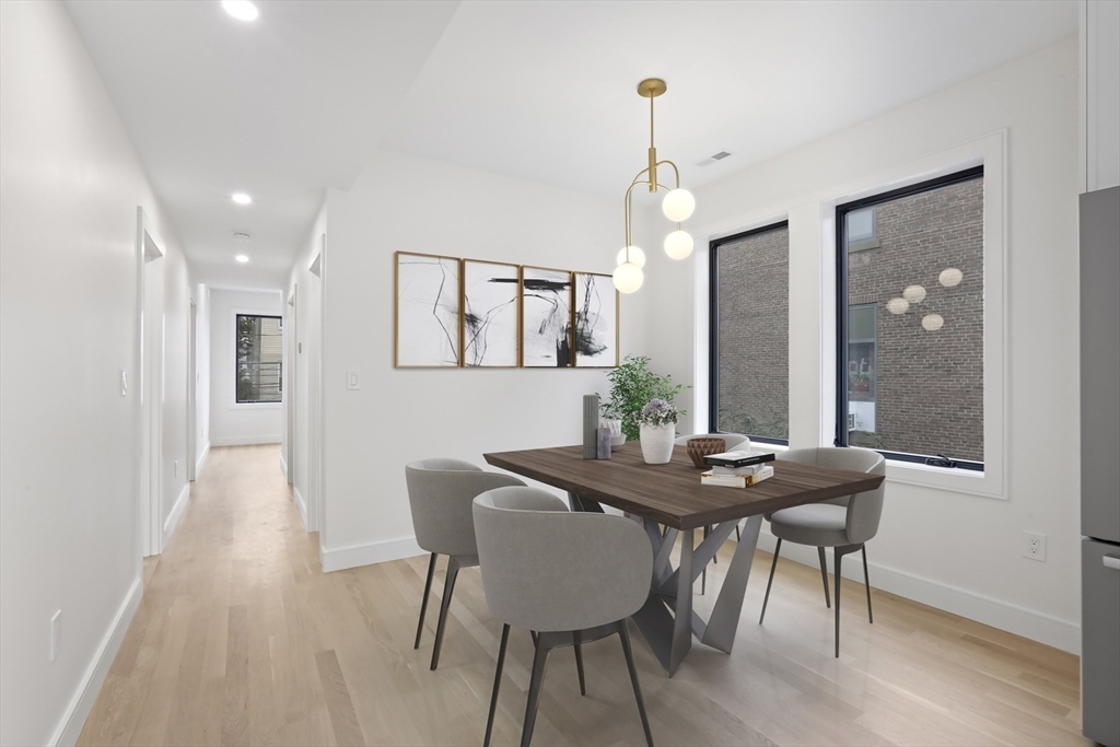 14 Bonair Street, Unit 14 Somerville, MA 02145 - Photo 7 of 39 a view of a dining room with furniture and wooden floor