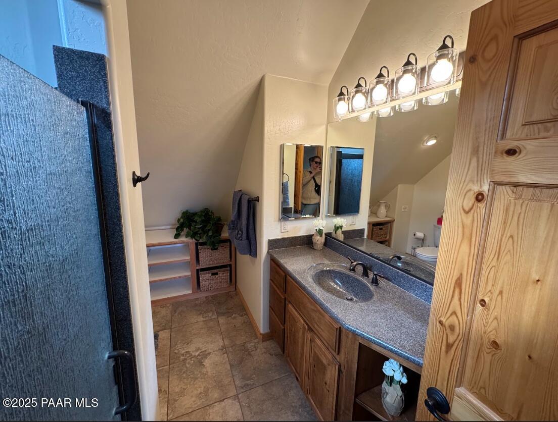 1740 West Bumblebee Road Chino Valley, AZ 86323 - Photo 16 of 44 a spacious bathroom with a double vanity sink and a mirror
