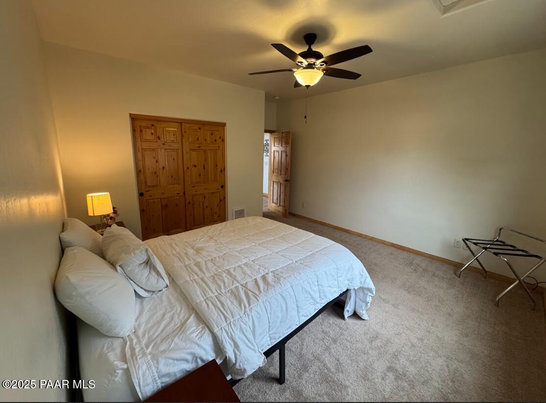 1740 West Bumblebee Road Chino Valley, AZ 86323 - Photo 17 of 44 a bedroom with a bed and a chandelier