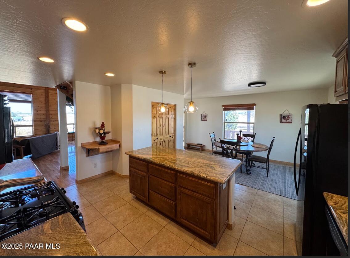 1740 West Bumblebee Road Chino Valley, AZ 86323 - Photo 8 of 44 a large kitchen with a table and chairs