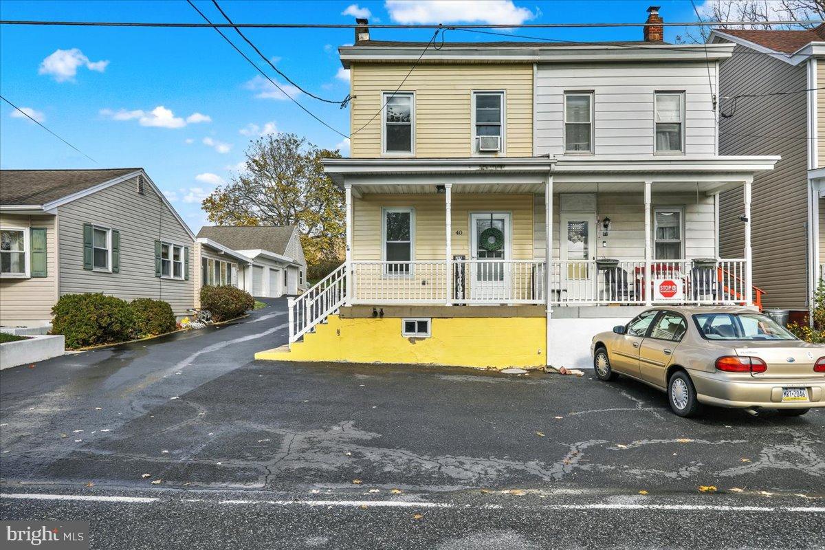 a view of a white house with swimming pool in front of it