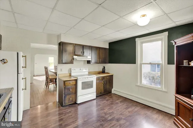 a kitchen with stainless steel appliances a stove a refrigerator sink and microwave