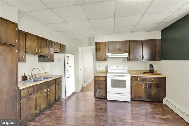 a kitchen with stainless steel appliances a stove sink and cabinets