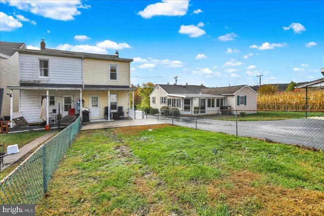 a view of a house with a yard patio and swimming pool
