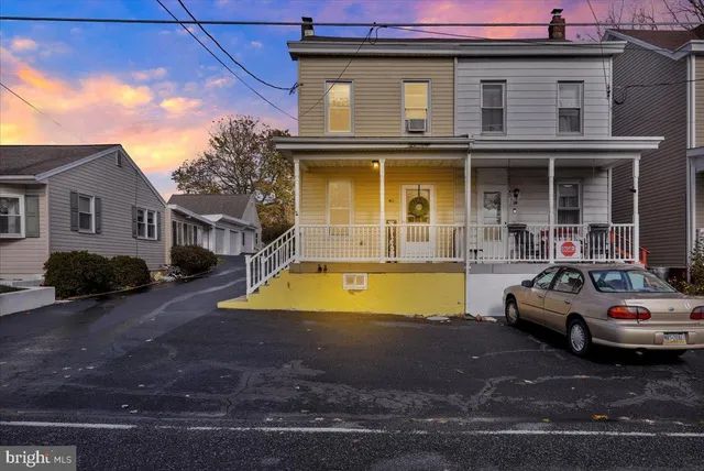 a view of a house with pool and a chairs