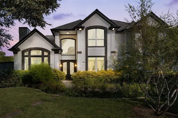 a front view of a house with a garden