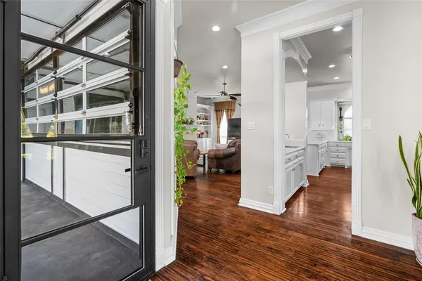 a kitchen with stainless steel appliances white cabinets and wooden floors