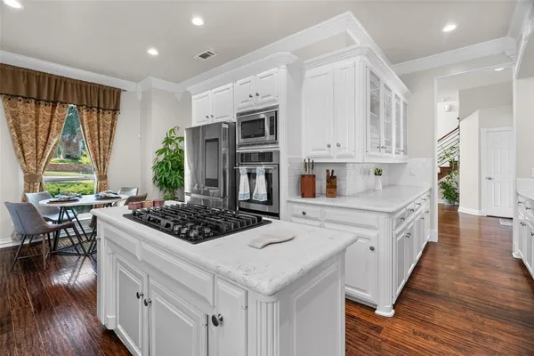 a kitchen with white cabinets and white appliances