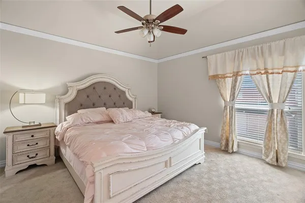 a spacious bedroom with a bed and a ceiling fan