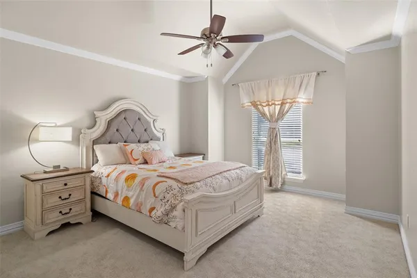 a bedroom with a bed a chandelier and a window