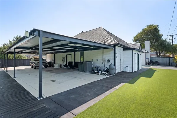 a view of a patio with table and chairs under an umbrella