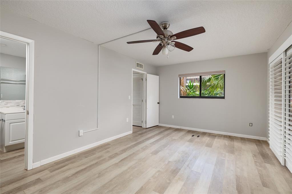 11708 Raintree Village Boulevard, Unit A Temple Terrace, FL 33617 - Photo 12 of 21 a view of a big room with wooden floor closet and windows