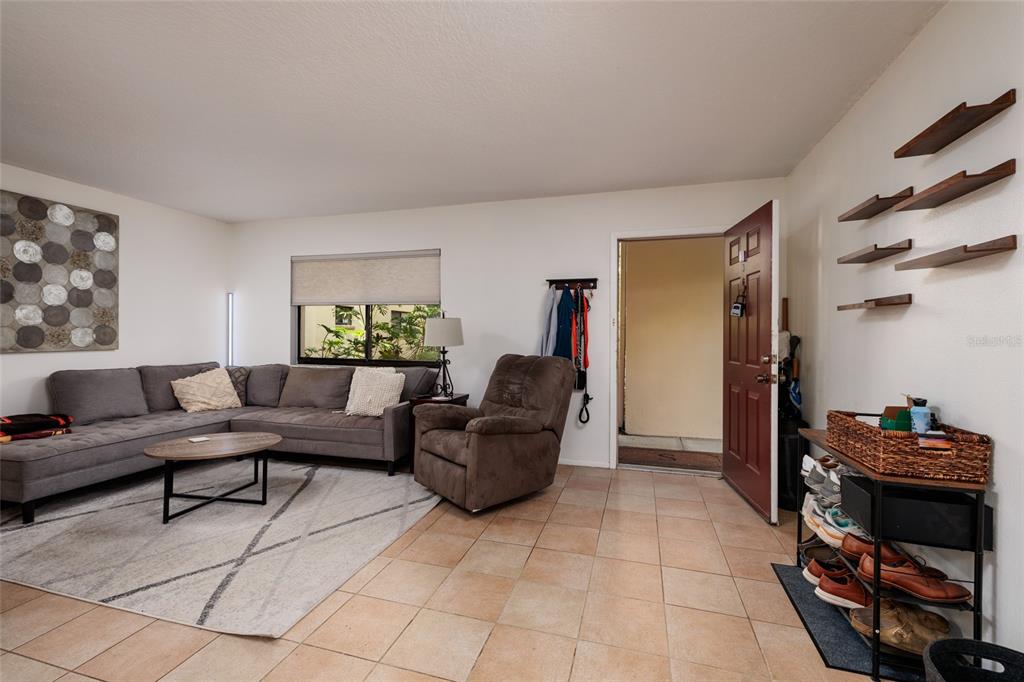 11708 Raintree Village Boulevard, Unit A Temple Terrace, FL 33617 - Photo 4 of 21 a living room with furniture and a window